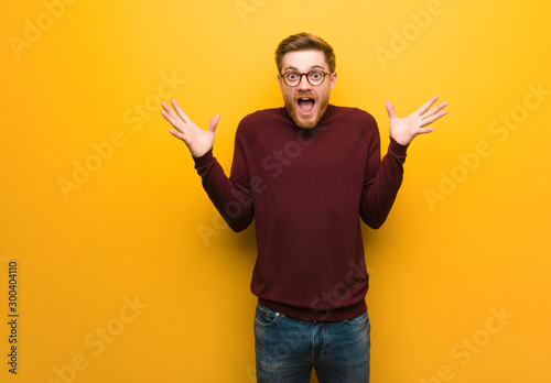 Fotografie Young smart man celebrating a victory or success