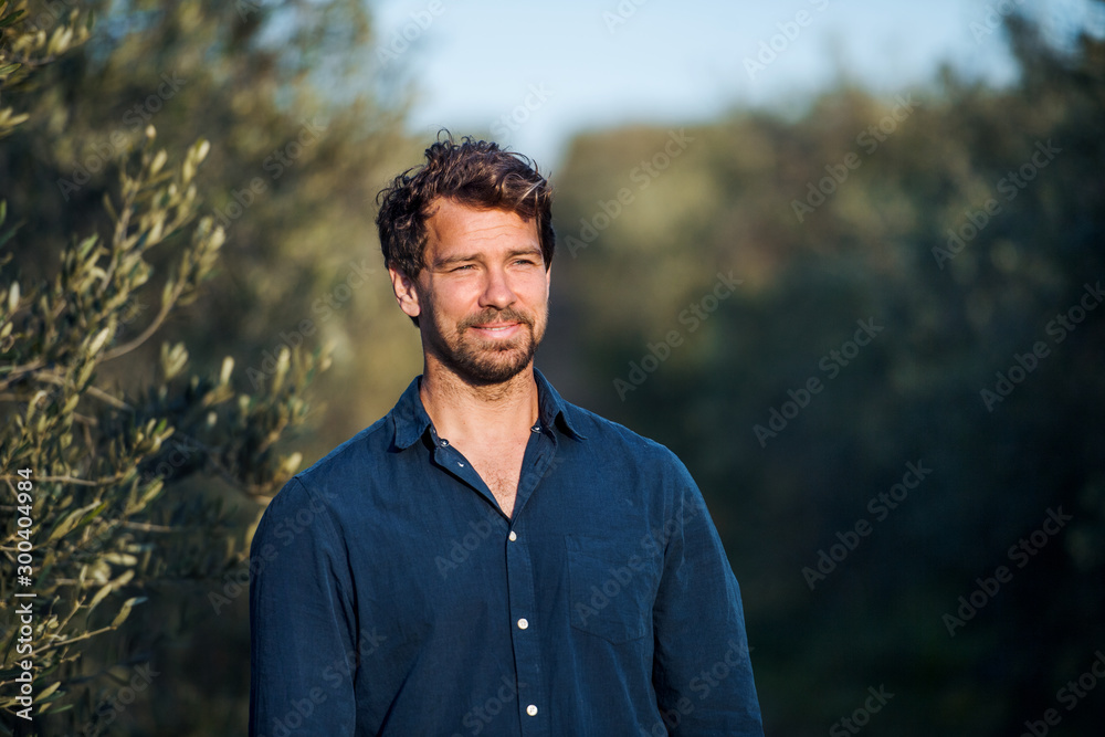 © Halfpoint - Portrait of mature man standing outdoors in olive orchard. © Halfpoint - Portrait of mature man standing outdoors in olive orchard.