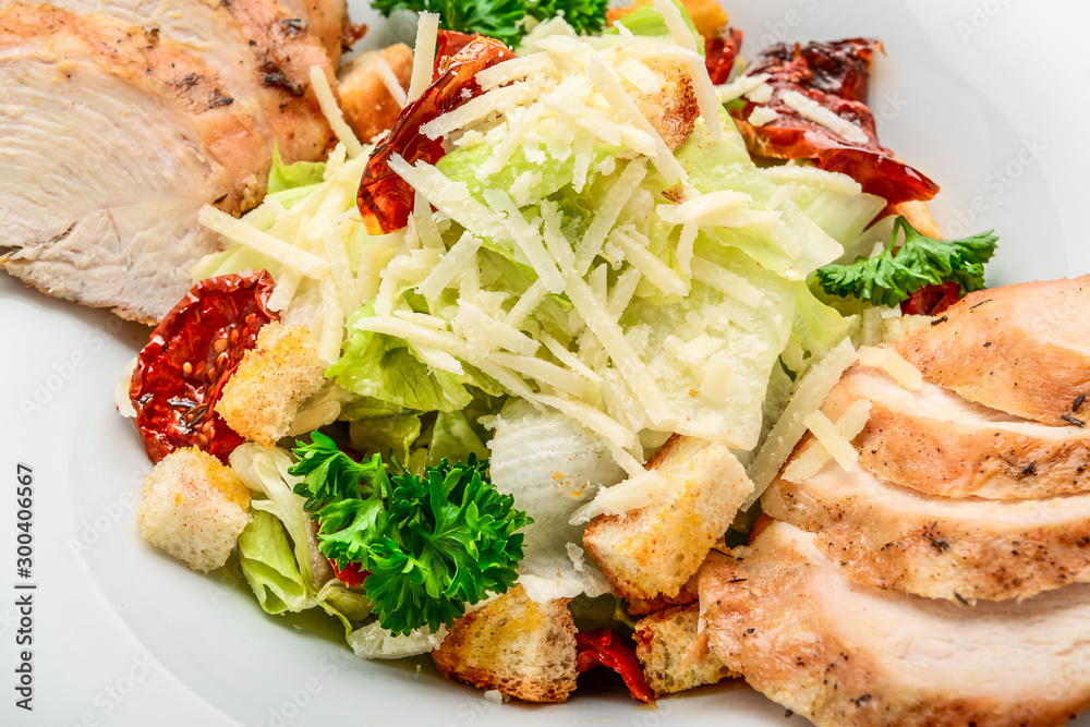 Caesar salad with croutons, quail eggs, cherry tomatoes and grilled chicken on a wooden background Caesar salad with croutons, quail eggs, cherry tomatoes and grilled chicken on a wooden background