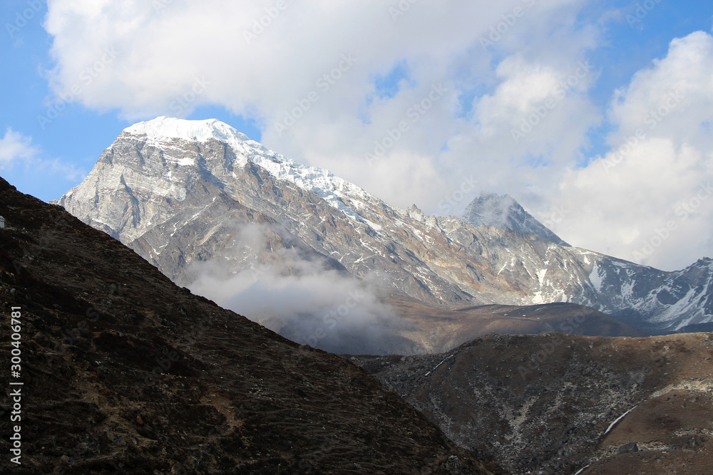 View of Chola (Kangchung La) mountain peak from Gokyo village in Himalayas in Sagarmatha national park. The summit is covered with snow and ice. Route to Everest base camp in Nepal through Gokyo lakes View of Chola (Kangchung La) mountain peak from Gokyo village in Himalayas in Sagarmatha national park. The summit is covered with snow and ice. Route to Everest base camp in Nepal through Gokyo lakes