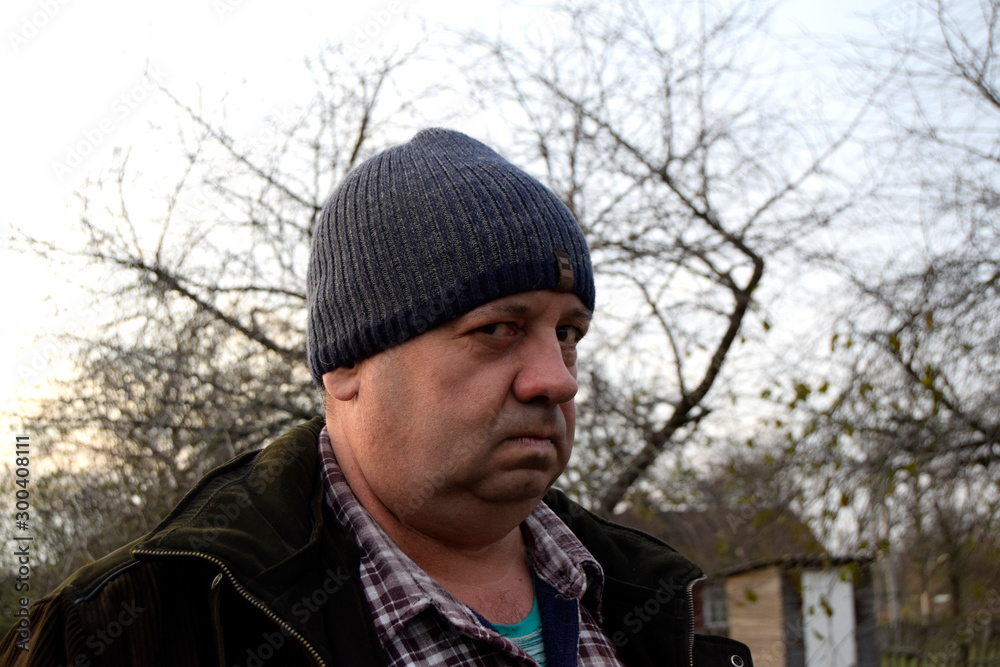 Portrait of an adult man with a cunning and aggressive facial expression. Man has funny face. Сlose up Portrait of an adult man with a cunning and aggressive facial expression. Man has funny face. Сlose up