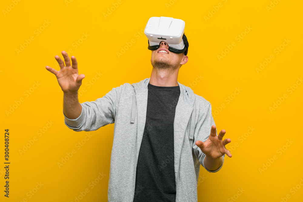 Young caucasian man using a virtual reality glasses