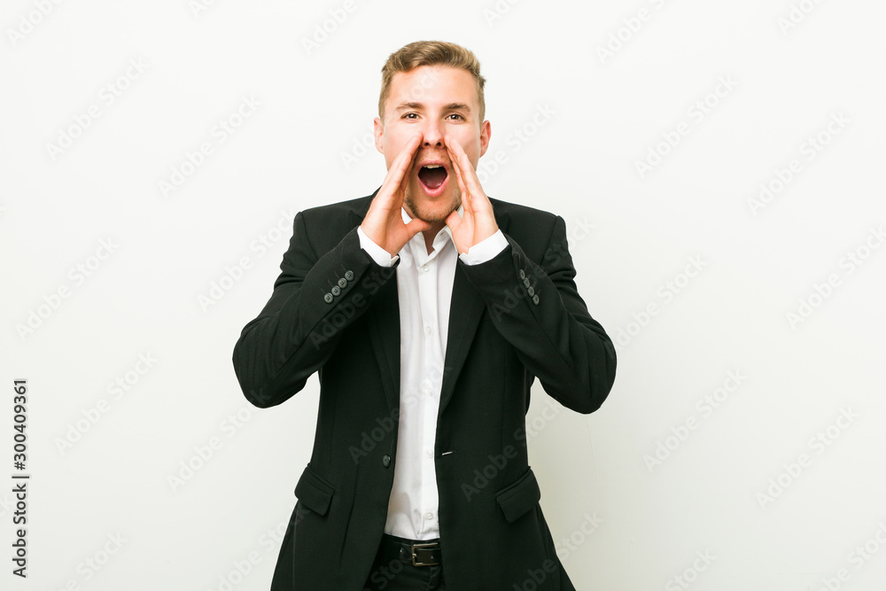 Young caucasian business man shouting excited to front. Young caucasian business man shouting excited to front.
