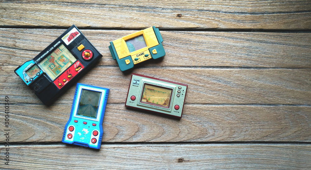 Old portable game console, Nintendo game & watch octopus and others on  wooden background. foto de Stock | Adobe Stock