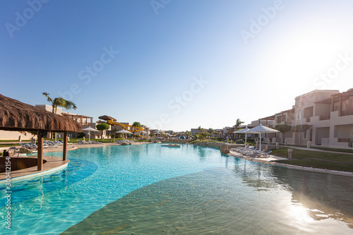 sunshade umbrellas and sunbeds near pool