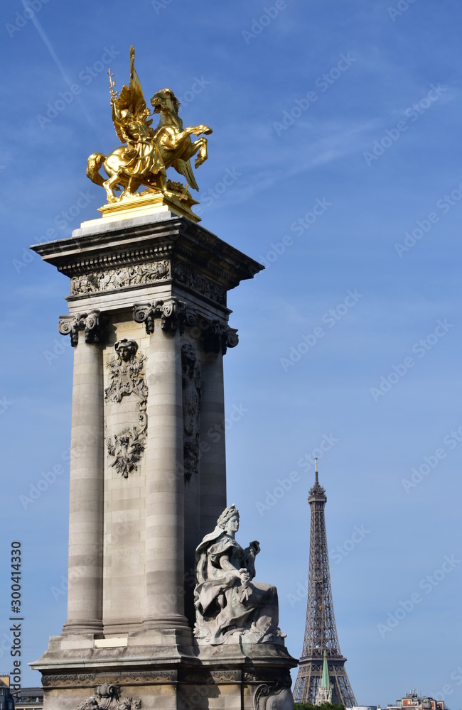 Tour Eiffel from Pont Alexandre III with blue sky. Paris, France.