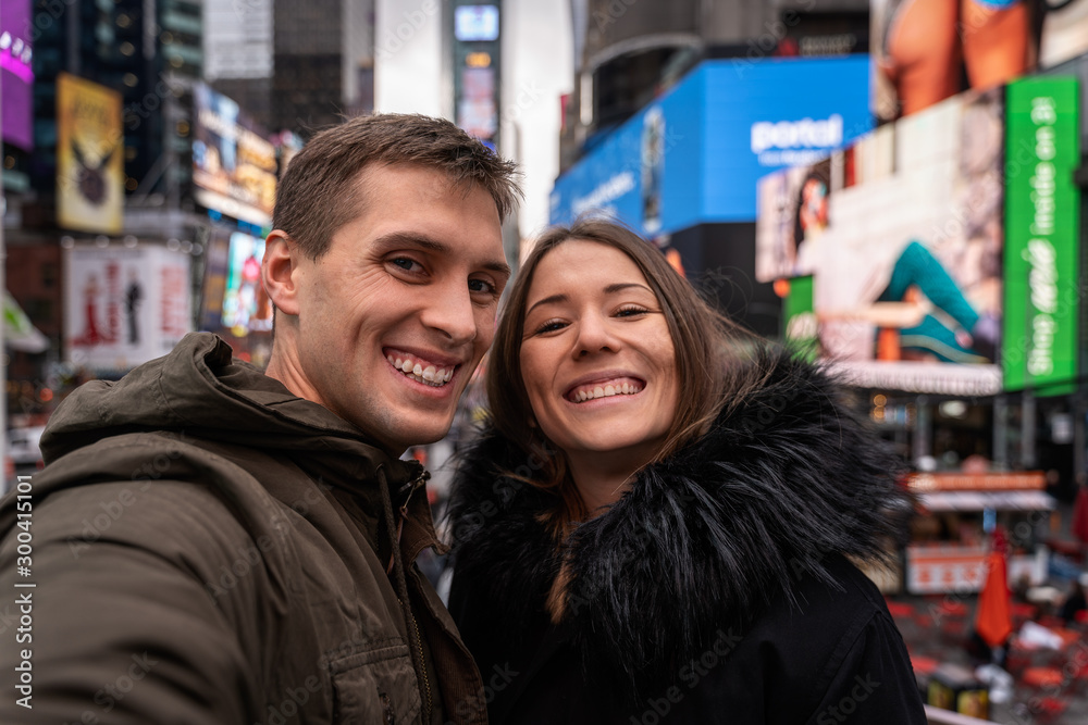young couple self portrait in times square