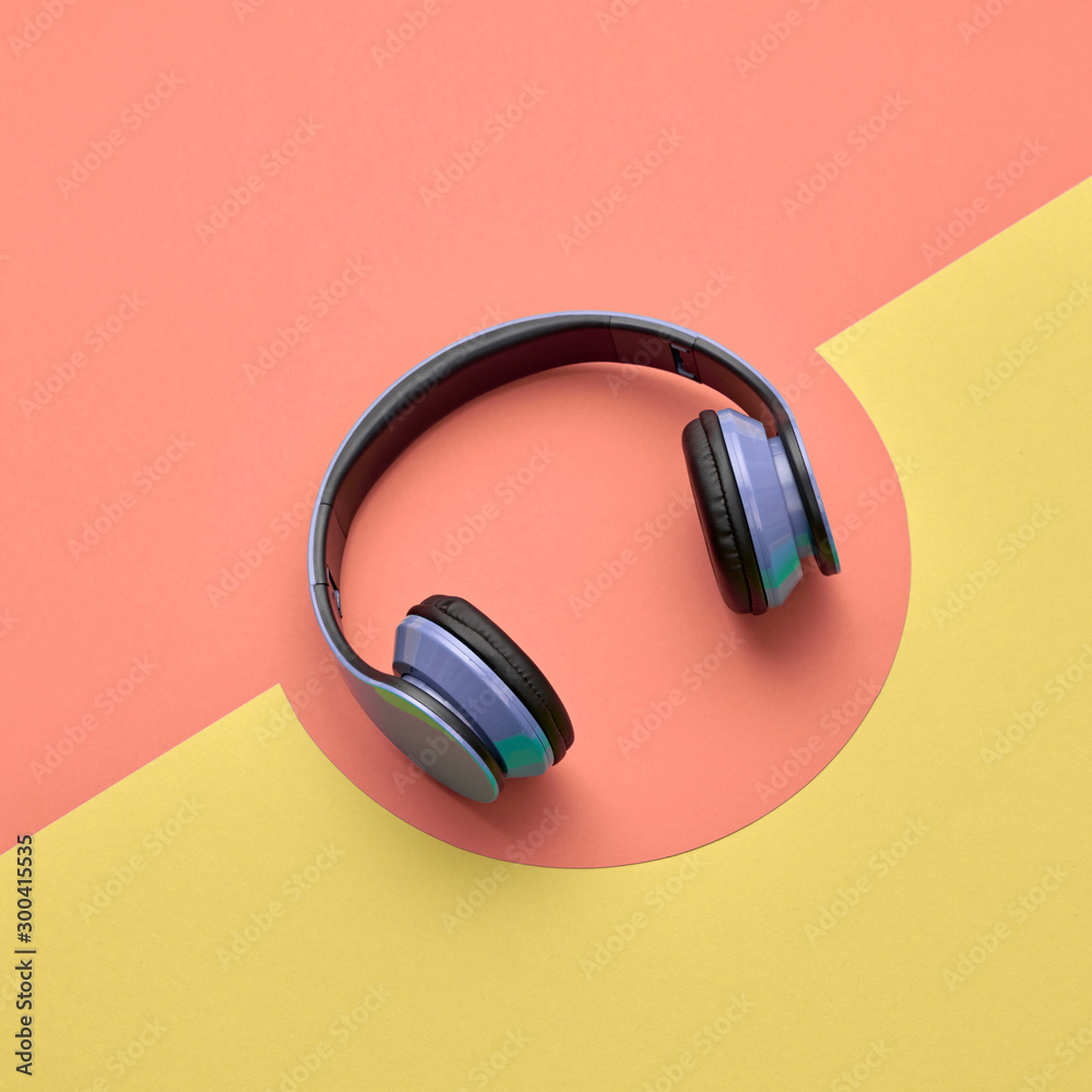 Minimal fashion, Trendy headphones. Music vibration on yellow geometry background. Hipster DJ accessory Flat lay. Art creative summer vibes fashionable pop art style. Sweet pastel design color Minimal fashion, Trendy headphones. Music vibration on yellow geometry background. Hipster DJ accessory Flat lay. Art creative summer vibes fashionable pop art style. Sweet pastel design color