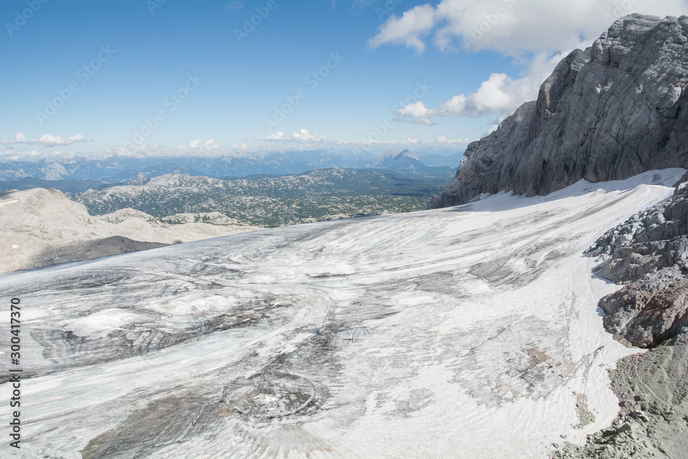Panoramic view of gigantic glacier, melting snow