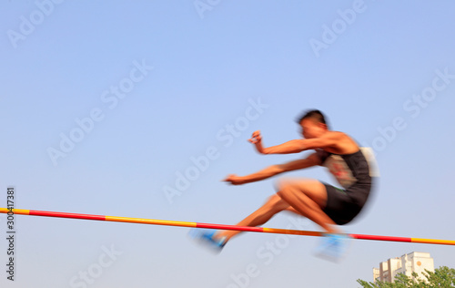 men high jump athletes in the playground