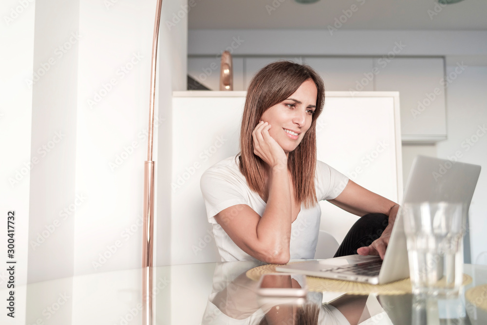 Adult woman working with laptop at home Adult woman working with laptop at home
