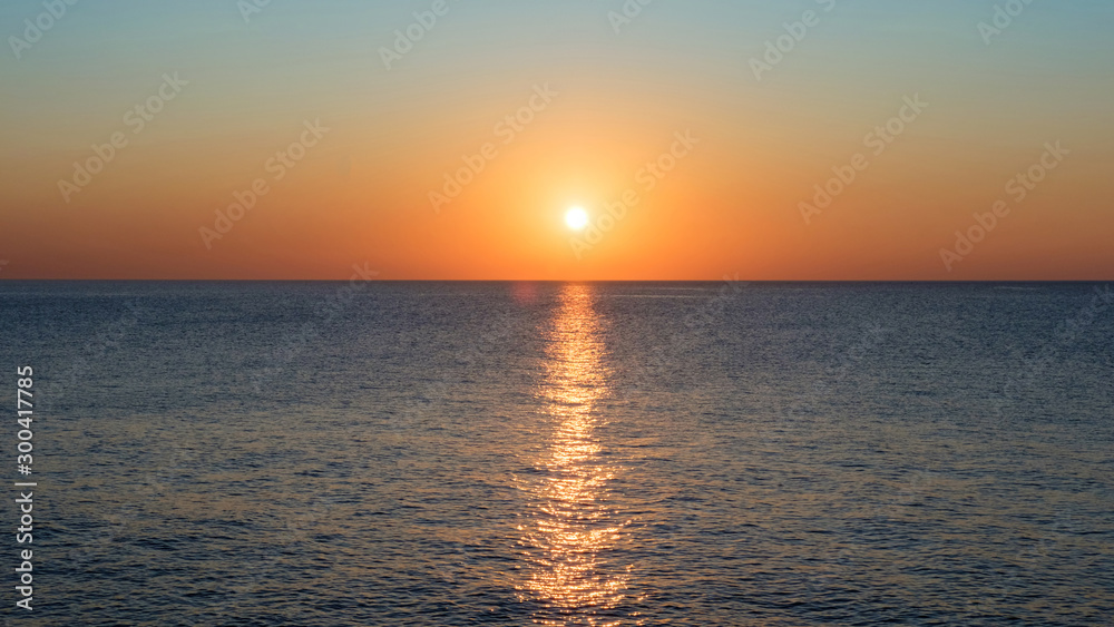 View of the calm sea and sunset sky