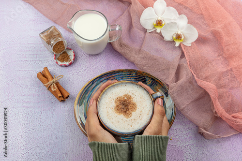 Girl's hand hold Traditional Turkish Drink Salep. Turkish salep (milky traditional hot drink). photo
