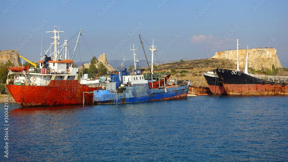 Old abandoned shipyard with scrap boats left to rust in Elefsina area, Attica, Greece