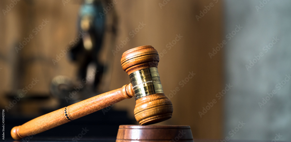Law and Justice concept. Mallet of the judge, books, scales of justice. Gray stone background, reflections on the floor, place for typography. Courtroom theme. Law and Justice concept. Mallet of the judge, books, scales of justice. Gray stone background, reflections on the floor, place for typography. Courtroom theme.