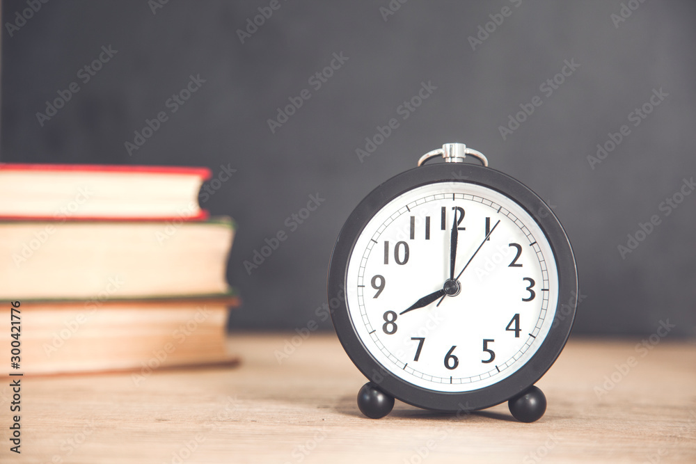 books with clock on desk books with clock on desk
