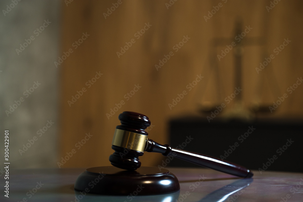 Law and Justice concept. Mallet of the judge, books, scales of justice. Gray stone background, reflections on the floor, place for typography. Courtroom theme. Law and Justice concept. Mallet of the judge, books, scales of justice. Gray stone background, reflections on the floor, place for typography. Courtroom theme.