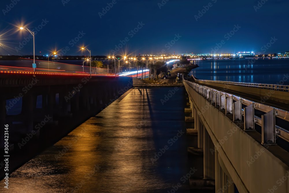 Obraz premium Tampa Bay at night with cars passing and city lights