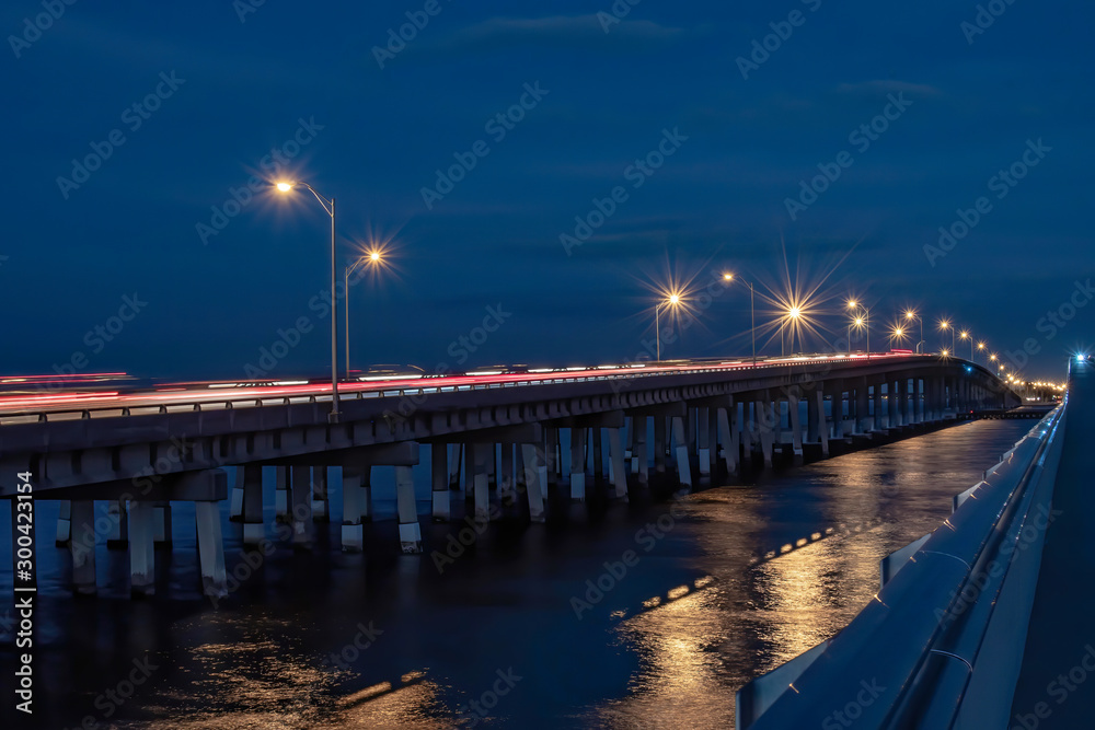 Tampa Bay at night with cars passing and city lights