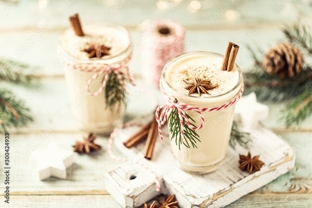 Eggnog. Traditional Christmas drink, spiced egg-milk cocktail with nut topping. - obrazy, fototapety, plakaty 