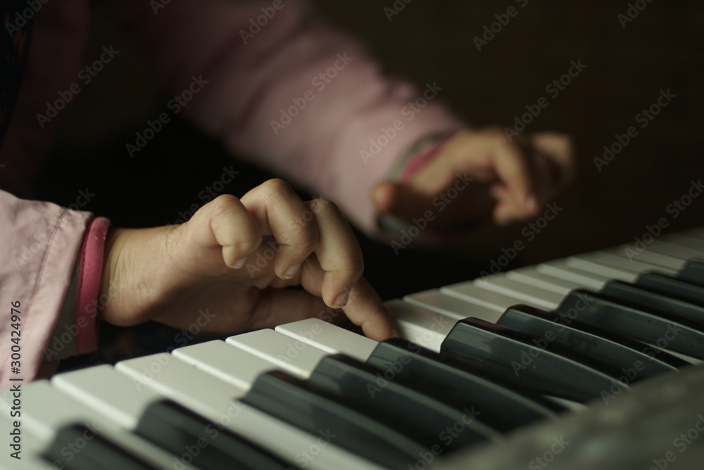 Fototapeta premium children's hands are playing the piano