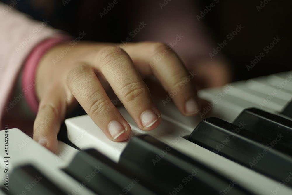 Fototapeta premium children's hand are playing the piano