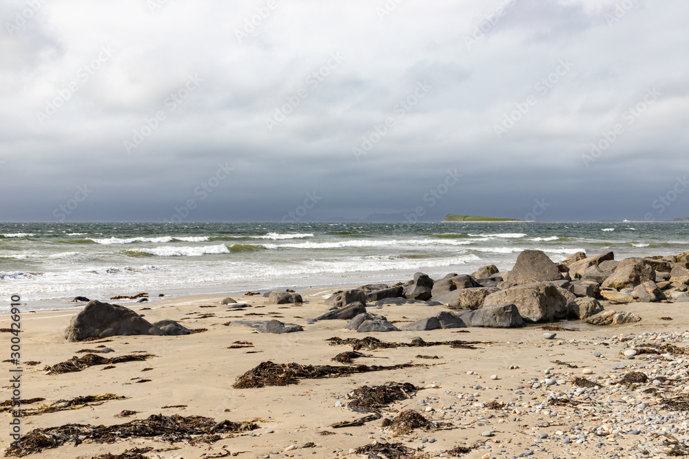 Waves and rocks at Bertra beach in cloudy day Waves and rocks at Bertra beach in cloudy day