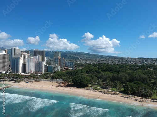 Panorama drone aerial view of Waikiki beach Honolulu Hawaii USA turquoise waters white golden sandy beach resorts along the shore 