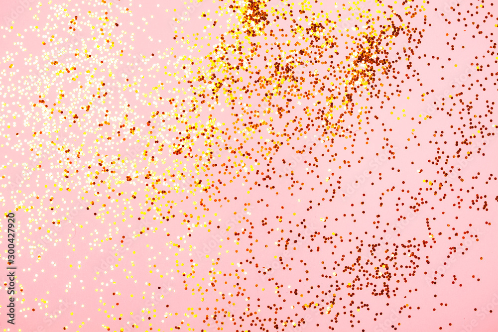 Pink confetti and stars and sparkles on pink background.