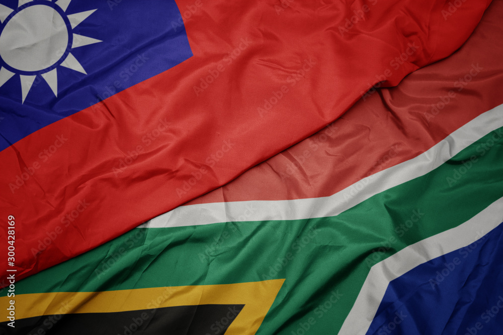 waving colorful flag of south africa and national flag of taiwan.