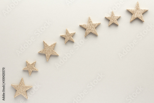 Christmas composition. Golden stars top view background with copy space for your text. Flat lay.