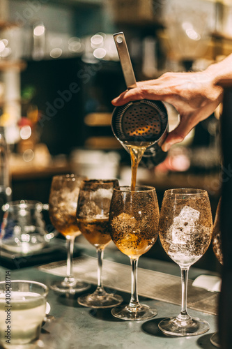 Bartender making cocktails at the bar, alcoholic drinks  