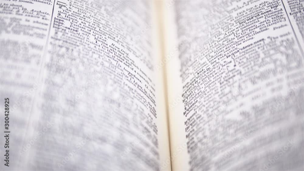 4K - Camera moves above the dictionary. Close-up