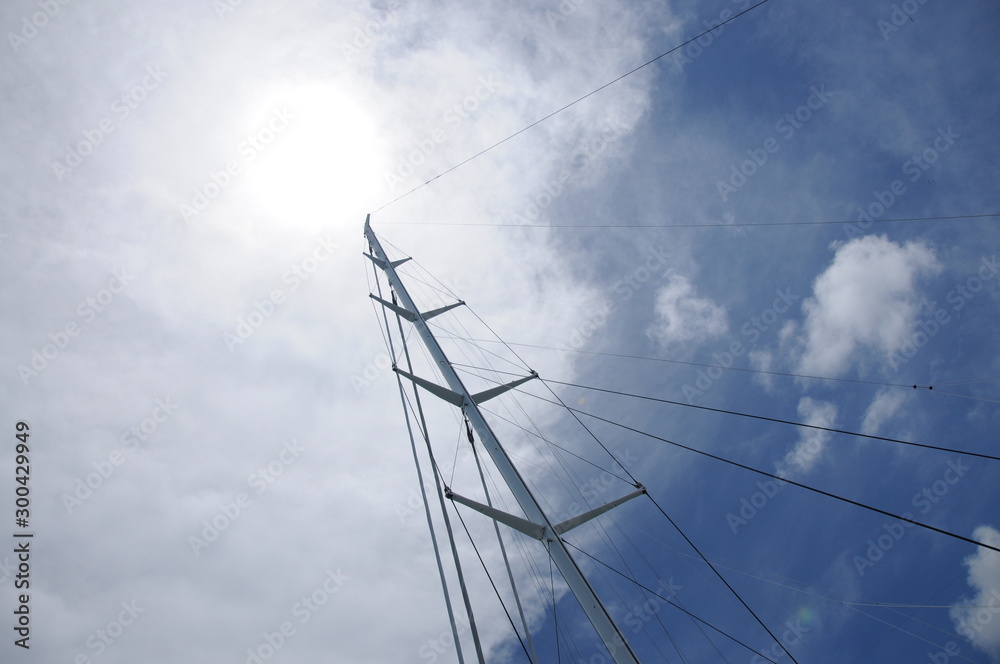 Mast of a marine vessel on the coast. Blue sky. Holidays in an exotic country