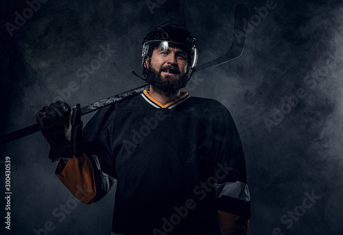 Wallpaper Mural Happy toothless hockey player is posing for photographer with hockey stick