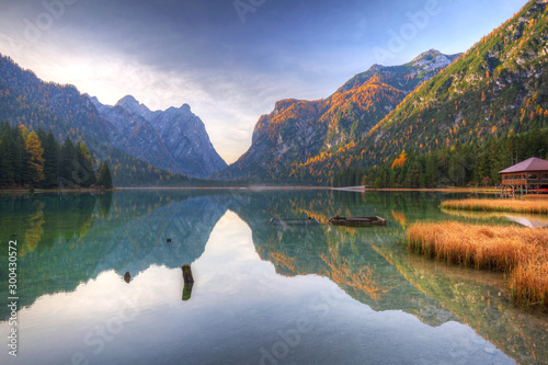 Fototapeta Naklejka Na Ścianę i Meble -  Dolomites mountains with reflection in Lago di Dobbiaca lake at autumn. Italy