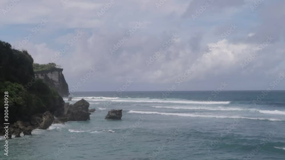 Beautiful rocky and sandy ocean coast on Bali island with clouds view. Horizon sky and waves. Beautiful rocky and sandy ocean coast on Bali island with clouds view. Horizon sky and waves.