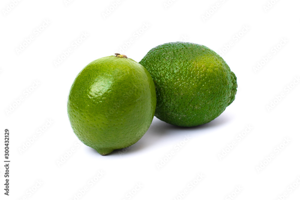 Lime green on a white background. Whole and halves limes isolated on white background. Full depth of field. Lime green on a white background. Whole and halves limes isolated on white background. Full depth of field.