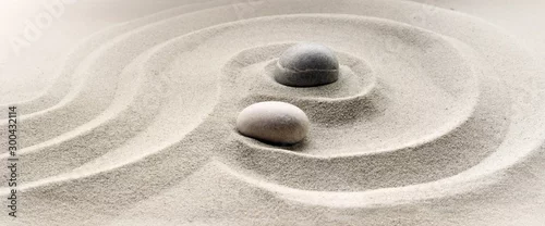 Obraz  z motywem zen garden meditation stone background with stones and lines in sand for relaxation balance and harmony spirituality or spa wellness