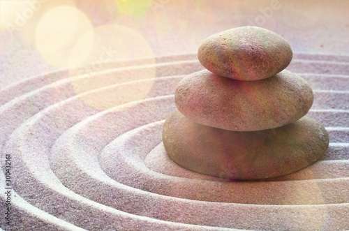 zen garden meditation stone background with stones and lines in sand for relaxation balance and harmony spirituality or spa wellness photo