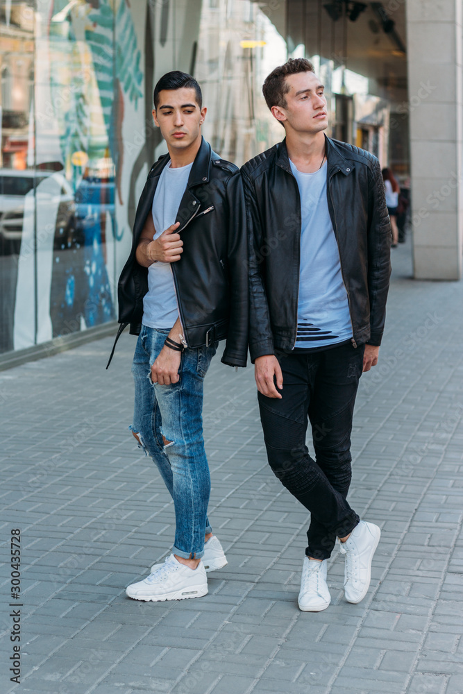 beautiful and attractive guy is standing in the city, posing. walk around the city in black glasses. communication. meeting friends. beautiful and attractive guy is standing in the city, posing. walk around the city in black glasses. communication. meeting friends.
