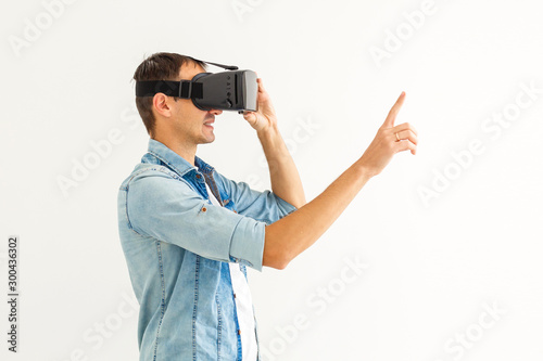 Young man with virtual reality glasses. Modern technologies. The concept of future technology.
