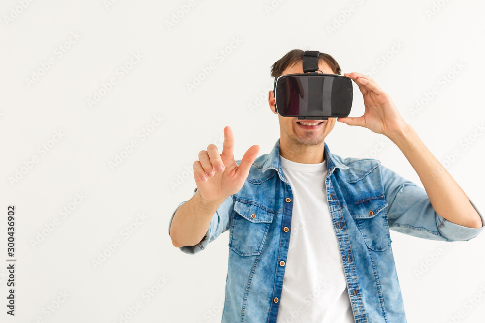 Young man playing games with virtual reality (VR) goggles Young man playing games with virtual reality (VR) goggles