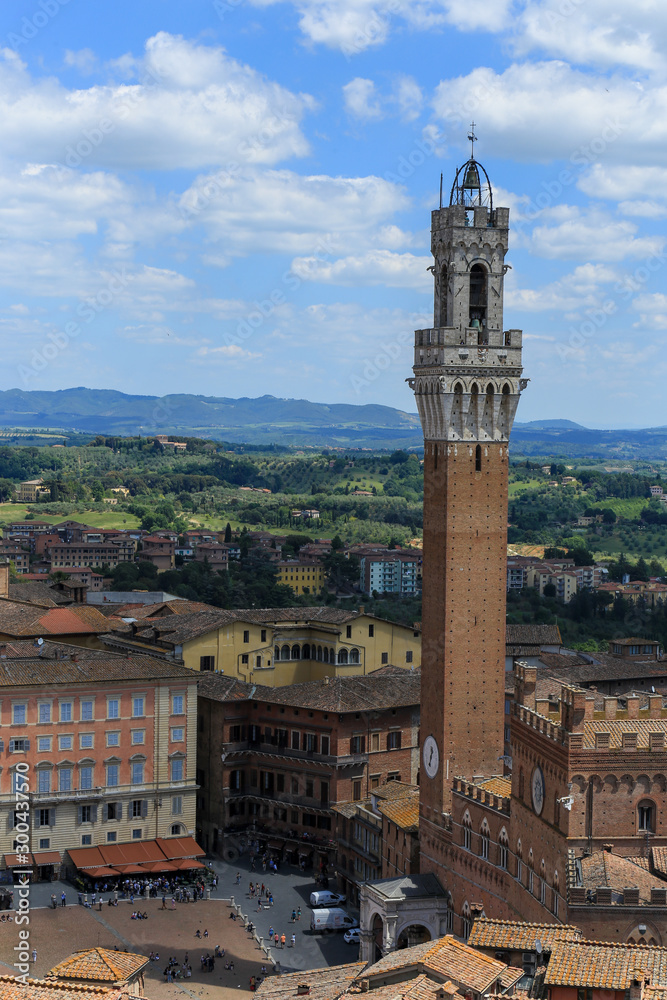view of the tower of siena and the buildings surround and the background landscape