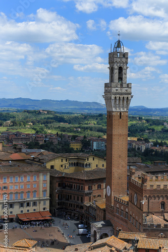 view of the tower of siena and the buildings surround and the background landscape