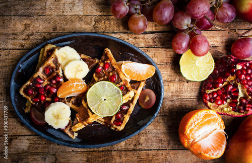 Homemade waffles served with various fruits