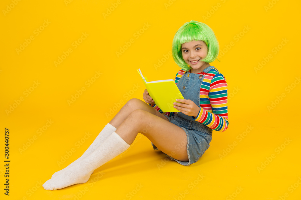 Relax and read book. Adorable small child read book yellow background. Cute little girl enjoy reading. You cant buy happiness but you can buy book. Book store. Library. Bibliopole Relax and read book. Adorable small child read book yellow background. Cute little girl enjoy reading. You cant buy happiness but you can buy book. Book store. Library. Bibliopole