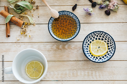 Fototapeta Naklejka Na Ścianę i Meble -  Autumn hot herbal tea with honey, cinnamon and lemon. Top view. Image toned.
