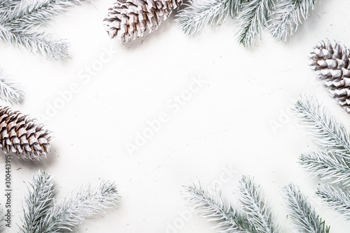 Christmas background with fir tree and decorations on white.