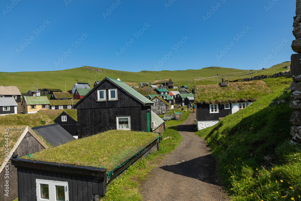 Beautiful village of Mykines with colorful houses with grass on the roofs, Mykines island, Faroe Islands, Europe.